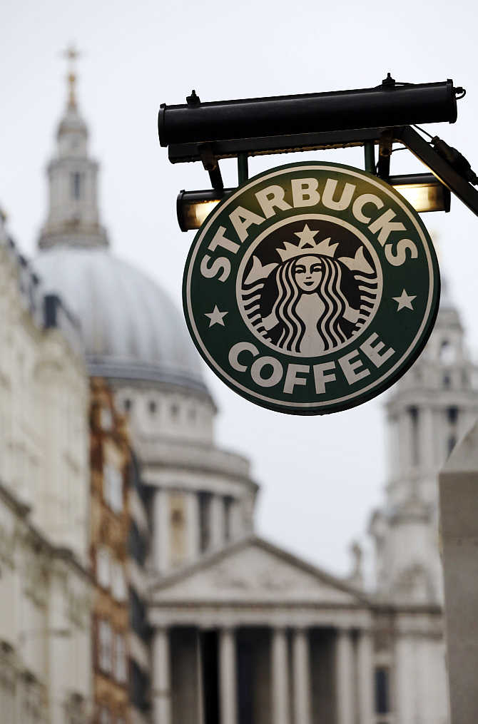 St Paul's Cathedral is pictured behind a signage for a Starbucks coffee shop in London.