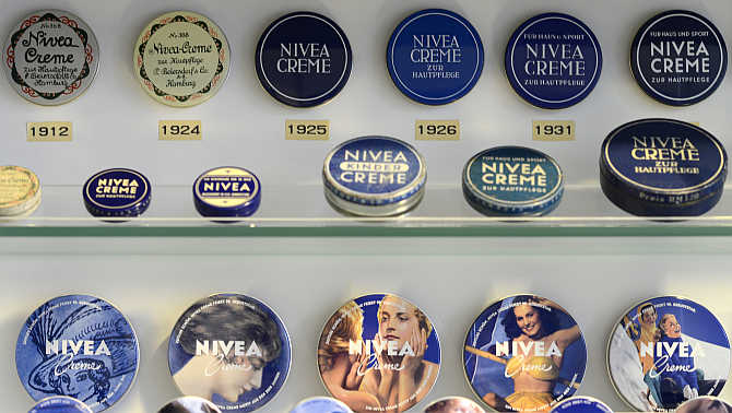 A collection of Nivea skin cream tins in a showcase beside a production line of German company Beiersdorf in Hamburg.