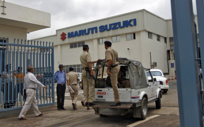A vehicle carrying Indian policemen enters Maruti Suzuki's plant at Manesar, in the northern Indian state of Haryana.