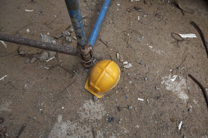The helmet of a labourer lies at the construction site near Manesar.
