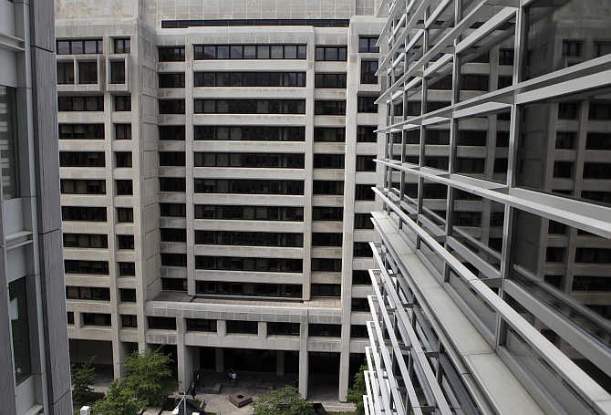 The International Monetary Fund headquarters building is seen through a World Bank window in Washington, DC.