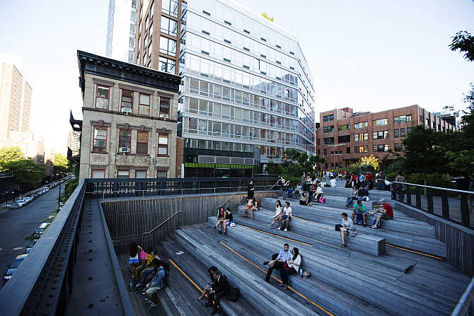 Pedestrians sit in a viewing area on the High Line park in New York.