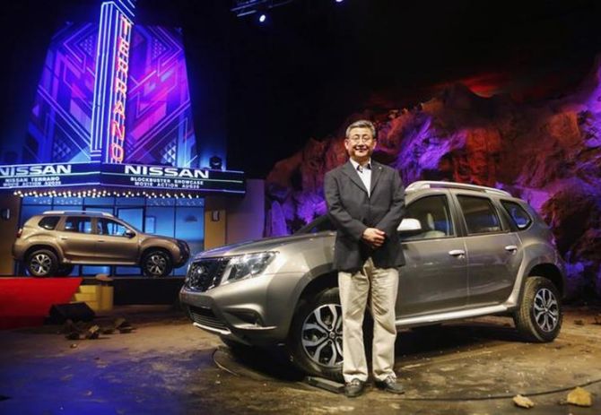 Kenichiro Yomura, CEO of Nissan Motor India, poses with the newly-unveiled Nissan Terrano compact sport utility vehicle in Mumbai.