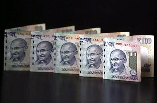 Rupee breaches 64-level, recovers after RBI steps in
