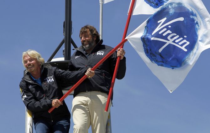 Virgin Group head Richard Branson (L) and explorer Chris Welch stand on the crows nest of the Cheyenne, a 38m (125 ft) catamaran at a news conference in Newport Beach, California.