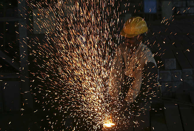 A worker cuts steel bars inside a factory on the outskirts of Hyderabad.