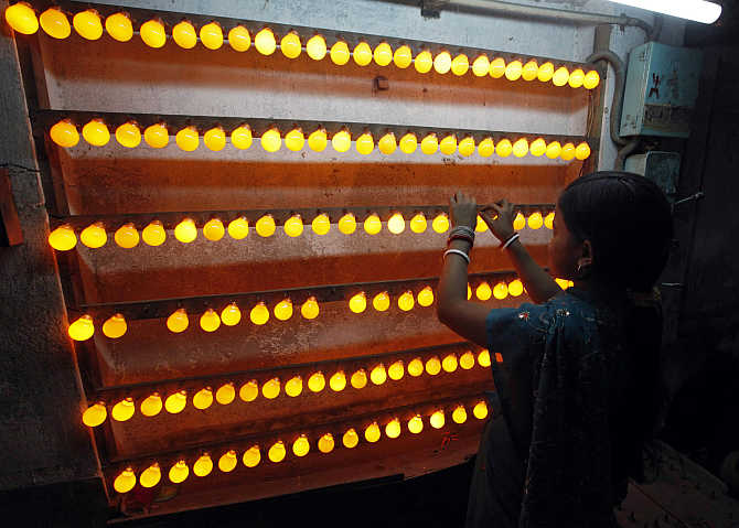 An employee works inside a bulb-manufacturing factory in Kolkata.