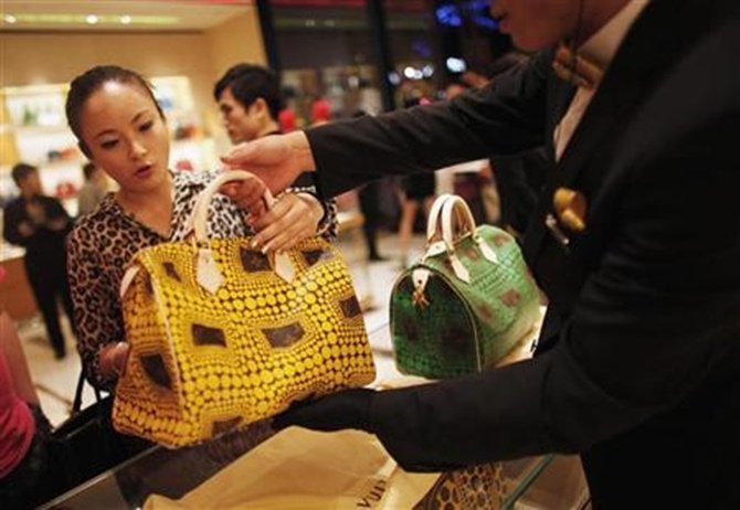 A woman shops in a Louis Vuitton store in downtown Shanghai.