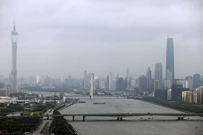 The 610-metre high Guangzhou TV & Sightseeing Tower, left, in Guangzhou.