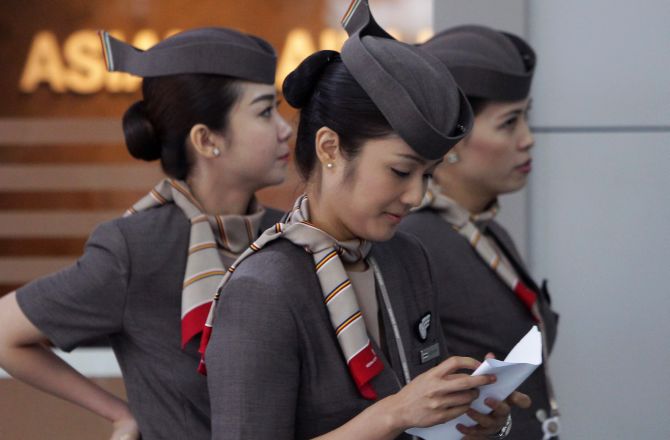 Asiana Airlines crew prepare to board their flight at the Incheon International Airport.