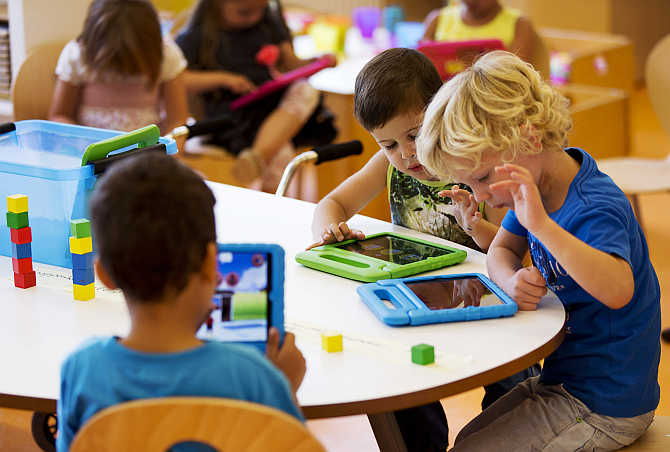 Students play with iPads at the Steve Jobs school in Sneek, the Netherlands.