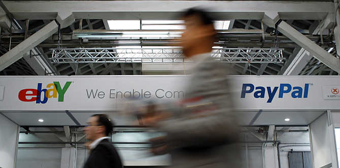 Visitors walk past an ebay banner at the Mobile World Congress in Barcelona, Spain.