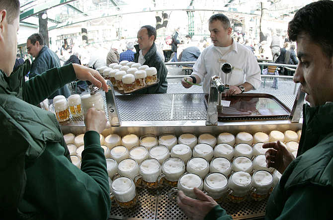 Beer is tapped at the opening of Vienna's Schweizerhaus, a traditional beer garden, at Vienna's amusement park in Austria.