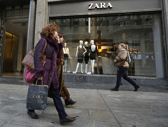 People walk past a Zara store in downtown Madrid, Spain.