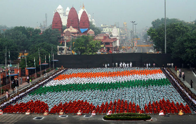 School children in coloured clothes form India's flag as they participate in a full-dress rehearsal for the country's Independence Day celebrations at the historic Red Fort in Delhi.