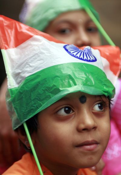 A child wears a cap made of national flag.