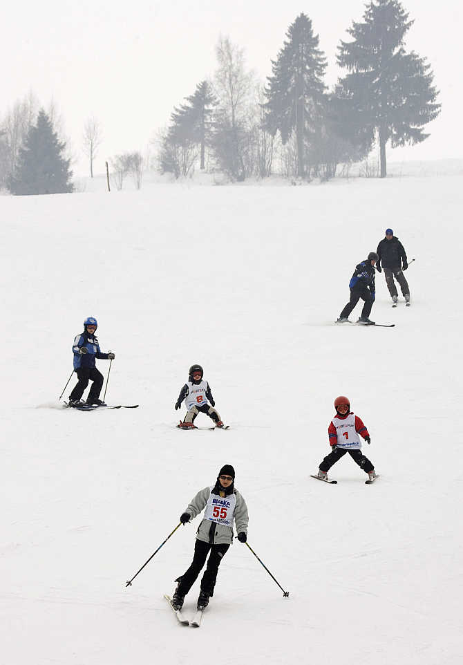 People enjoy skiing during the first spring day in the southern mountain town of Nowy Targ, some 400km south of Warsaw in Poland.