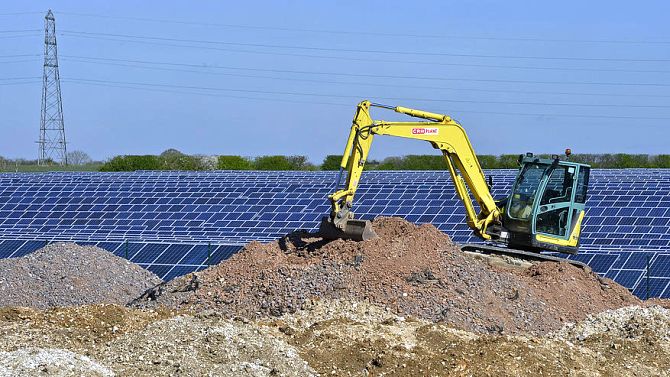 Construction work is seen at a field of solar panels in southern England.