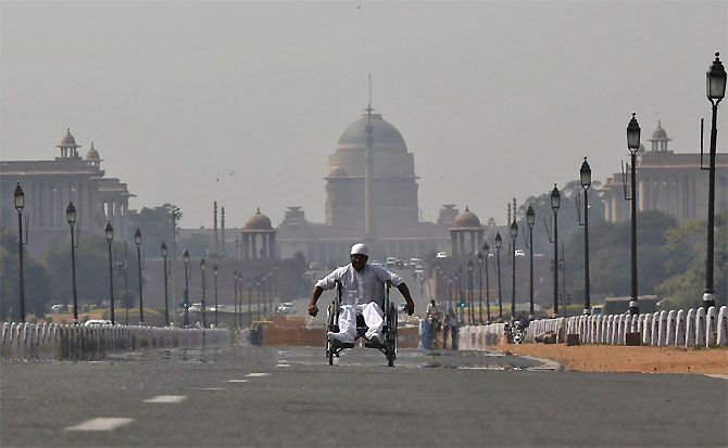 A man in a wheelchair makes his way to join protesters near Rashtrapati Bhavan.