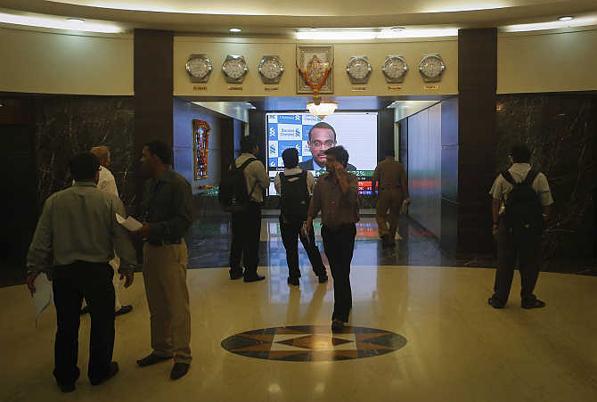 Employees stand in a lobby as they wait for the elevator inside Bombay Stock Exchange.