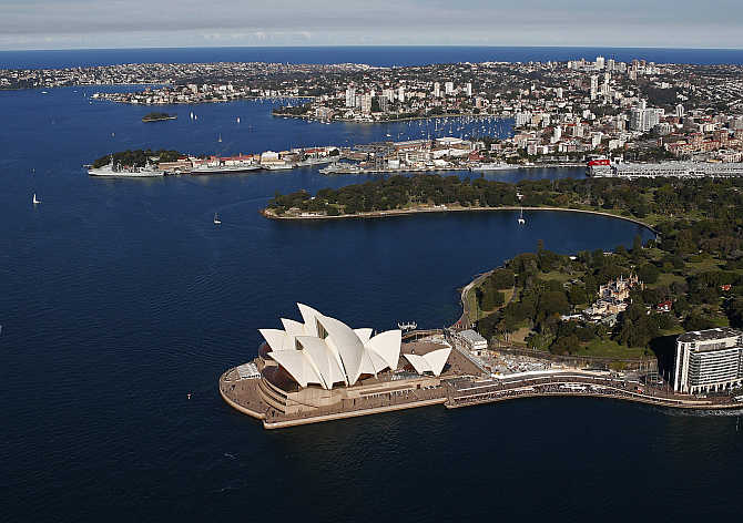 Sydney Opera House in front of eastern suburbs in Sydney, Australia.