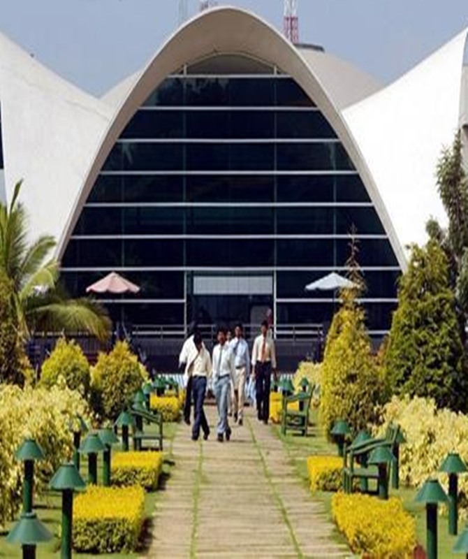 Staff walk in Infosys Technologies campus in Electronics City in Bangalore.