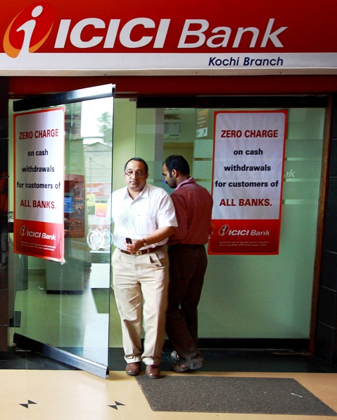 A man leaves an automated teller machine facility of ICICI bank in Kochi.