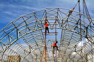 Image: Labourers fit iron rods at the construction site of a metro train station in Chennai.