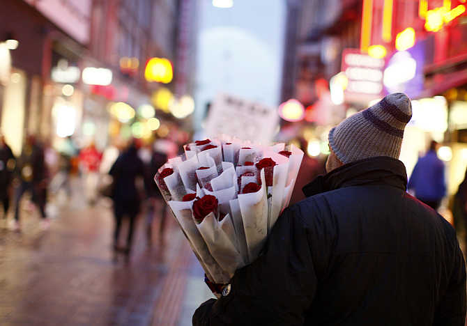 A man sells roses at a pedestrian road in central Copenhagen, Denmark.