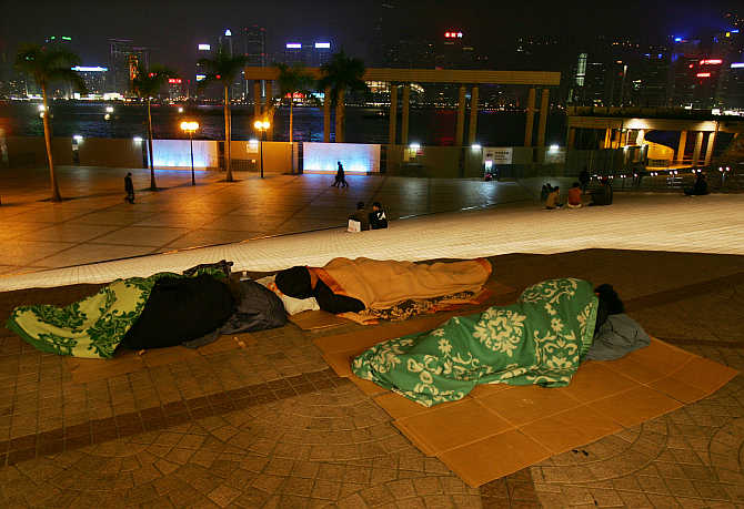 Homeless people sleep outside the Hong Kong Cultural Centre.