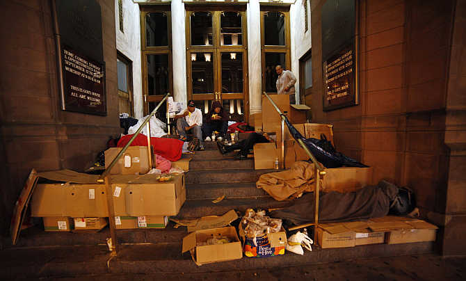 Homeless people eat food donated by a charity organisation in New York.