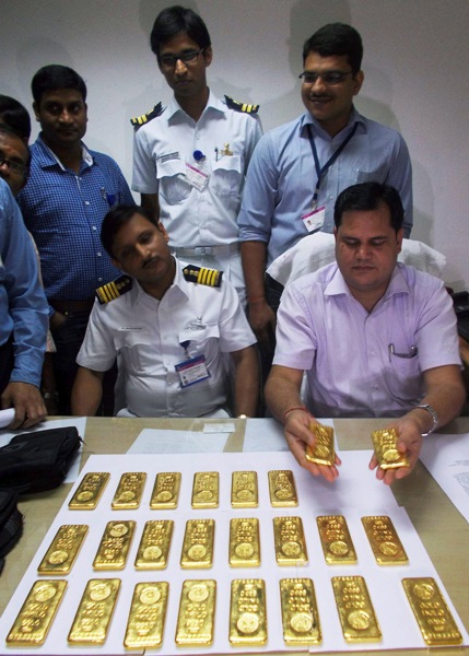 A customs officer displays seized gold bars at the international airport in Kolkata.