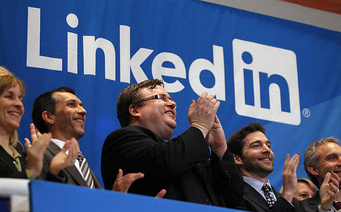 Founder of Linkedin Reid Garrett Hoffman, centre, applauds with CEO Jeffrey Weiner, secoond right, from the bell balcony at the New York Stock Exchange.