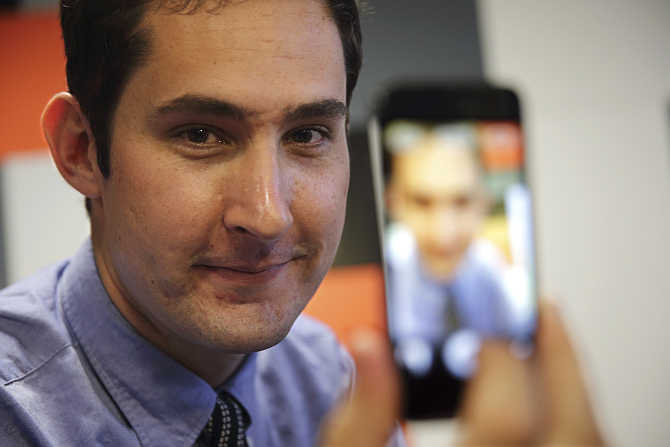 Kevin Systrom, CEO, Instagram, the popular photo-sharing app now owned by Facebook, displays his photo on a mobile phone at the LeWeb technology conference in Aubervilliers, near Paris, France.