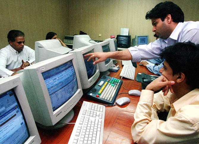 This file photo shows stock brokers at work in Mumbai.