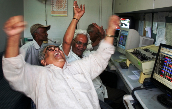 A file photo shows traders reacting inside a brokerage in Ahmedabad.