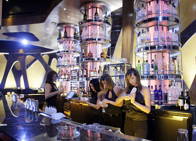 Employees ready the bar at the Union Restaurant and Lounge inside the Aria hotel-casino in Las Vegas, Nevada.