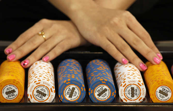Test chips with security measures by Gaming Partners International, a provider of casino currency and equipment, are displayed on a gaming table during the Global Gaming Expo Asia in Macau.