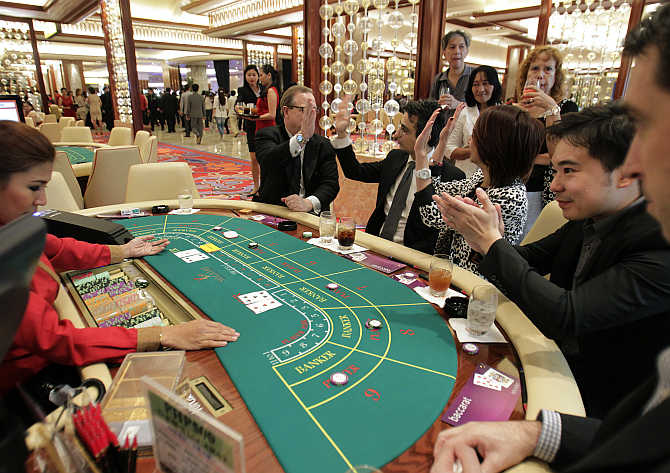 Foreigners play on a baccarat table during the opening of Solaire Casino-Resort in Pasay city, Metro Manila, the Philippines.