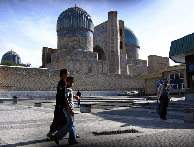 Pedestrians walk past Bibi Khanum mosque.