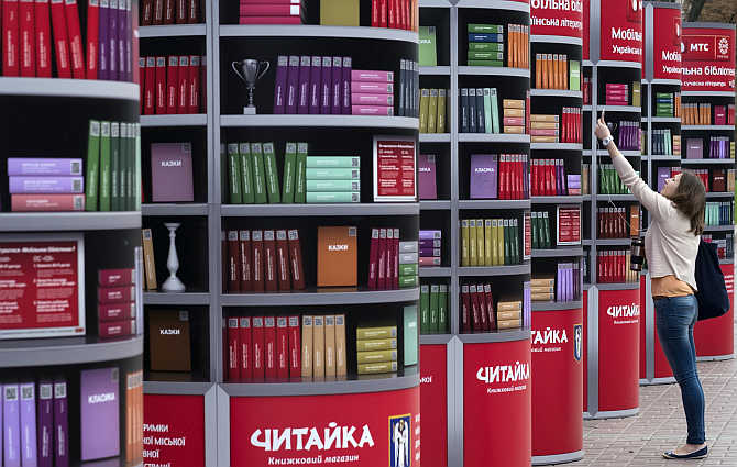 A woman uses her mobile phone to download books in a free mobile library in central Kiev, Ukraine.
