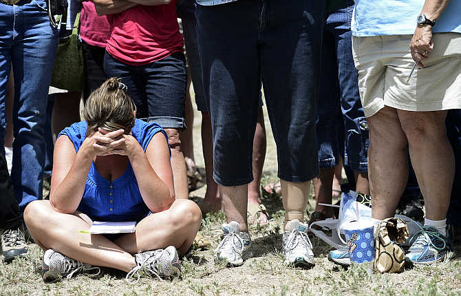 An evacuee lowers her head after hearing that residents are not going to be allowed to return to their homes yet, during a containment briefing on the Black Forest Fire near Colorado Springs, Colorado.