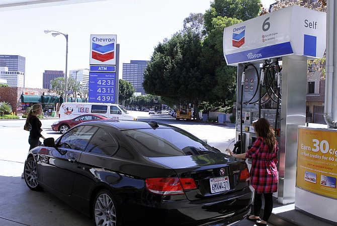 A woman stands at a petrol pump in Los Angeles,California.