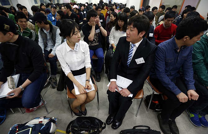 College students attend a class at a cram school in Busan, about 420km southeast of Seoul, South Korea. About 70 college students study for an exam they hope will guarantee them a job for life with Samsung Group.