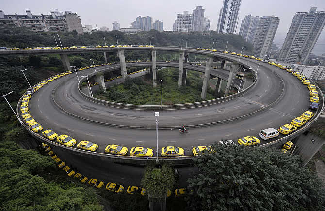 Taxis line up to get their tanks filled on a ramp in Chongqing municipality, China.