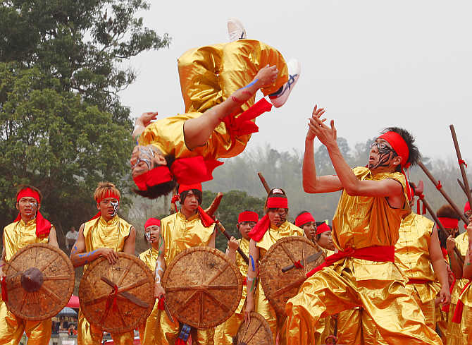 A performer flips in the air during the Song Jiang Battle Array competition in Neimen, Kaohsiung County, Taiwan.