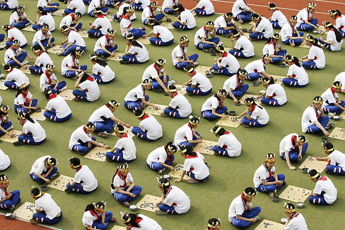 Students play the board game 'Go', known as 'Weiqi' in Chinese, at a primary school in Suzhou, Jiangsu province.