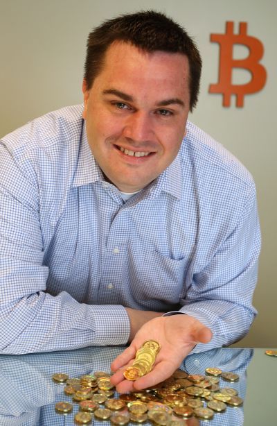 Software engineer Mike Caldwell holds physical Bitcoins he minted in his shop.