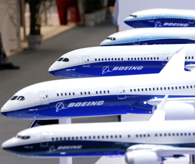 A visitor looks at a display of miniature Boeing passenger aircraft at Aviation Expo.