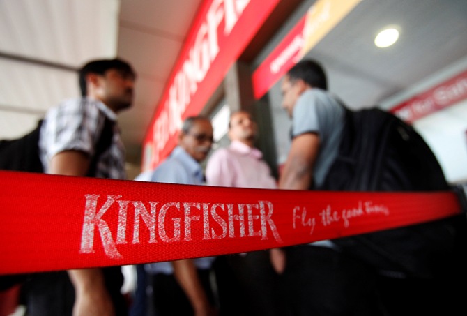 Customers stand at a Kingfisher Airlines reservation office at the domestic airport in Mumbai March 20, 2012.
